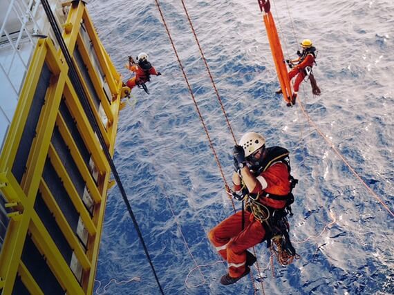Rope access technicians on offshore oil and gas facility